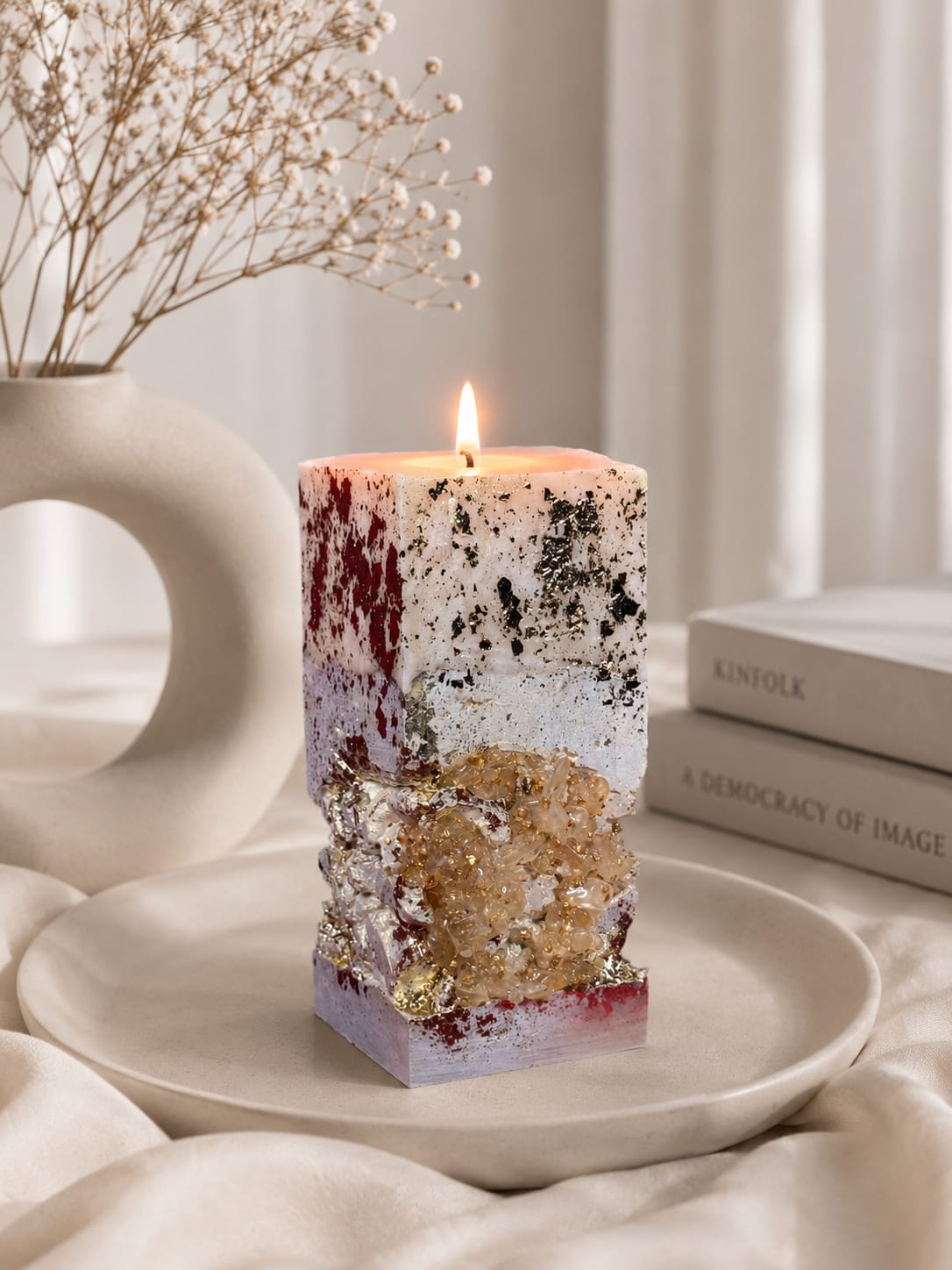 Luxury Concrete Candle with Crystal Texture Handmade square concrete candle with red, white, silver and crystal details in a luxury minimalist interior.