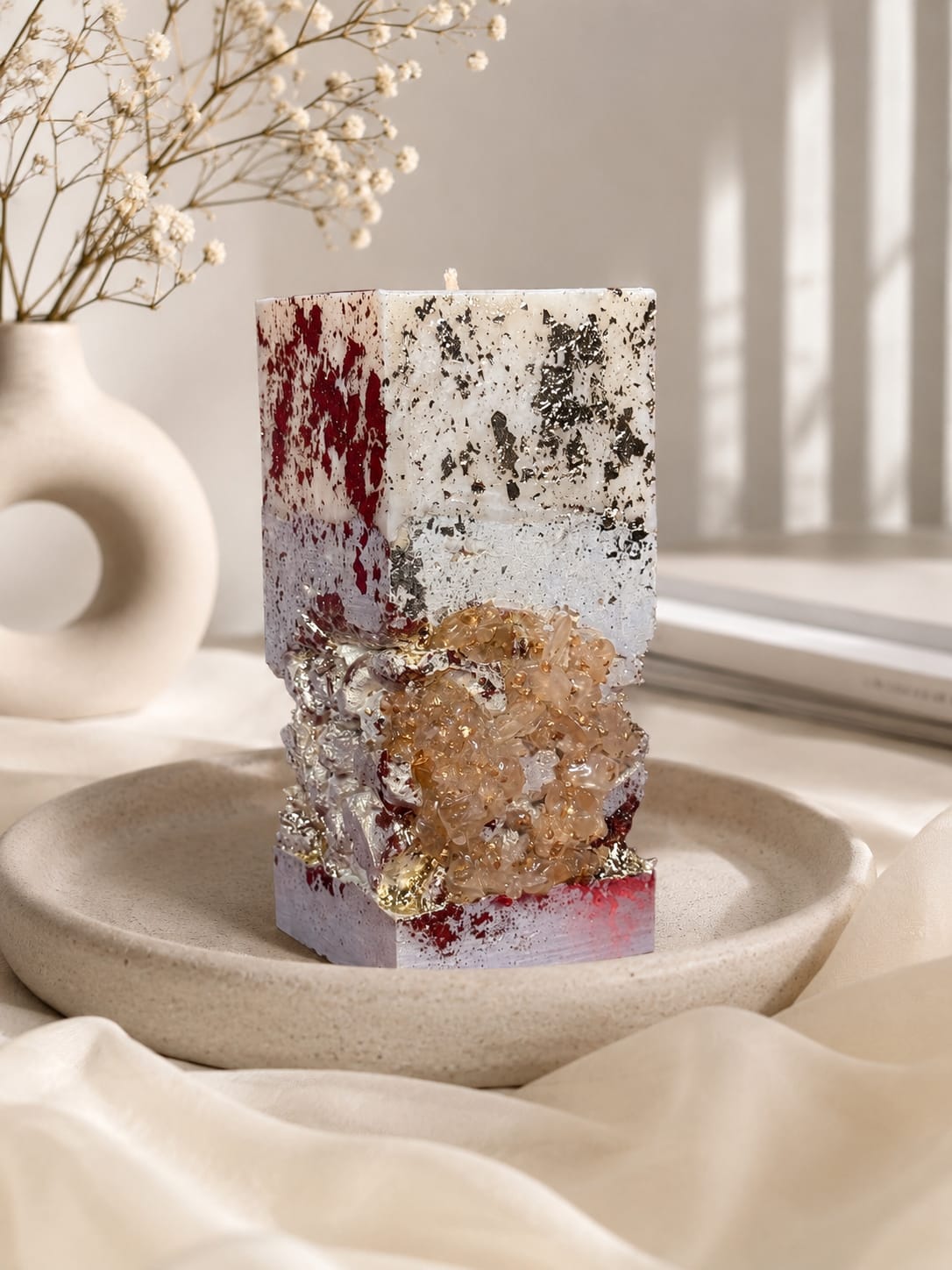 Burning Luxury Concrete Candle Burning handmade square concrete candle with crystal details in a bright luxury interior.