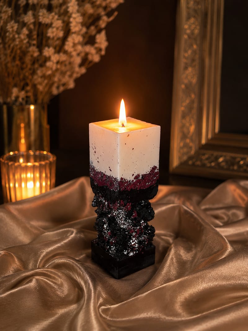 Handgefertigte schwarz-weiße Betonkerze mit Silberblatt und warmem Butterduft in modernem Luxus-Interieur.